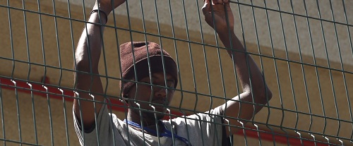 Refugee behind fence