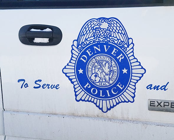 The Denver Police Department crest is shown on a squad car.