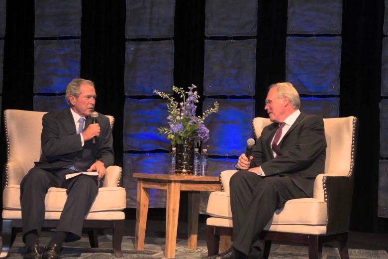 Former President George W. Bush speaks at the Korbel Gala as Dean Chris Hill listens, Sept. 10, 2013 | Photo: University of Denver via YouTube