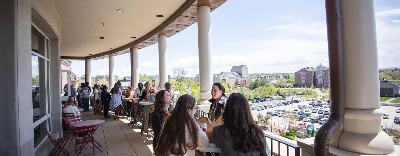 A group of FPS participants enjoys a break out on the balcony of Maglione Hall.