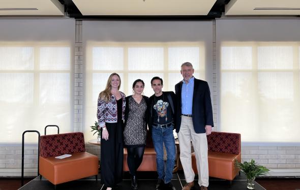Four individuals pose on stage for a picture before the event begins: Professor Marie Berry, Aisha Ahmad-Post, Francisco Graciano, and Dean Fritz Mayer