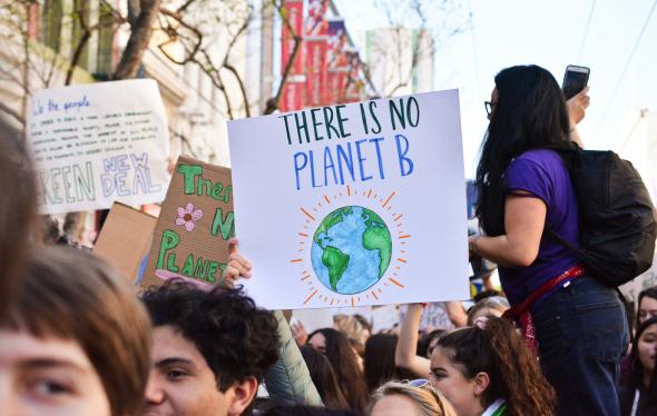 Climate activists holding sign that says "There is no planet B"