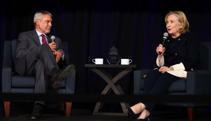 HIllary Clinton speaks on stage with Fritz Mayer.