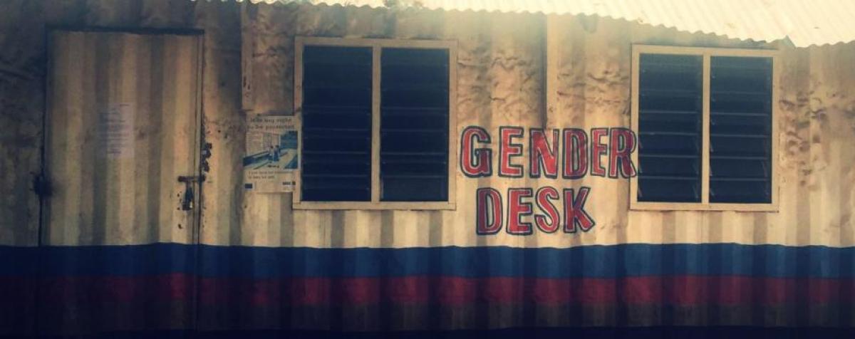 Tin-walled building with "Gender Desk" written on front